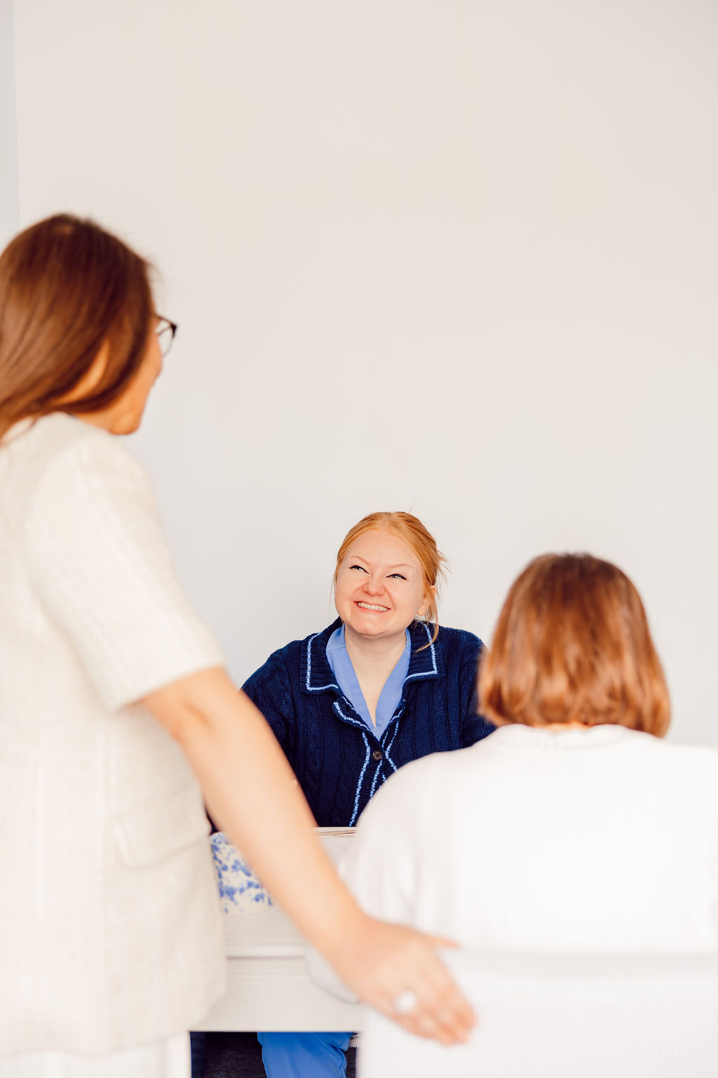 Therapist welcoming client in office